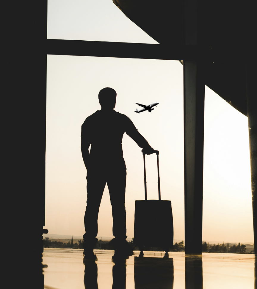 Traveller at airport with plane